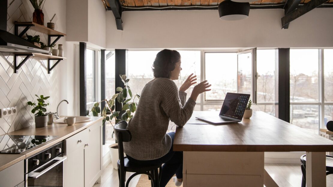 woman talking into laptop