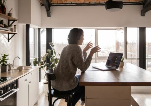 woman talking into laptop